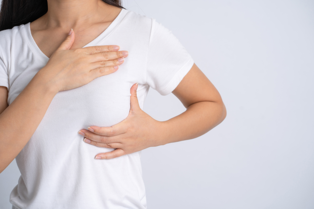 Woman performs self-breast exam