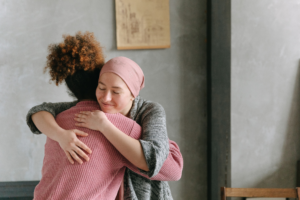 Doctor hugs cancer free patient